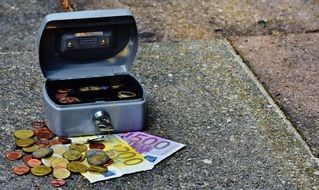 euro coins and banknotes in cash box