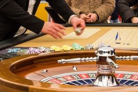 croupier near roulette in a casino