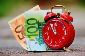 Photo of alarm clock and euro banknotes
