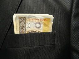 bills in jacket pocket close-up