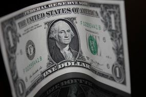 curved one Dollar Bill close up