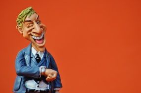 laughing ceramic figure on an orange background
