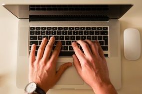 manager's hands on laptop keyboard