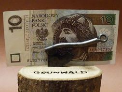 money on a stump with an ax