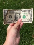 in the hands of a person 1 dollar