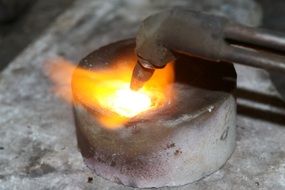 melting metal on fire