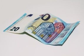 Euro banknote on a white surface