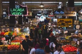 people buy fruits and vegetables in the market