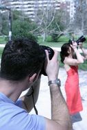 man photographing a girl