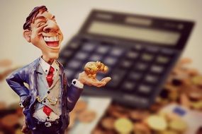 figure of a businessman on the background of the calculator