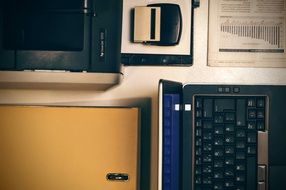 Laptop,Printer and Office Folder on table