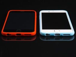 iPhones in red and white cases