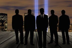 Silhouettes of businessmen on a background of skyscrapers