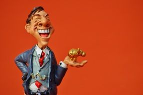 figurine of a businessman with a piggy bank in his hand