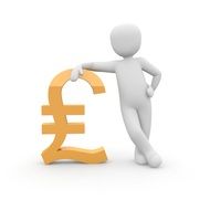 human figurine leaned on a banknote