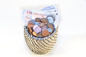 coins and banknotes in a basket