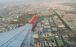 aircraft wing over the city