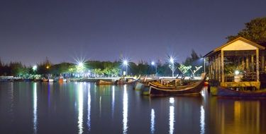 boats near the lighted pier