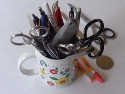 Pens and scissors in the cup