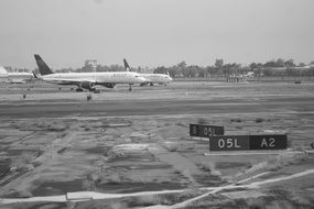 airplanes on the landing strip, black and white