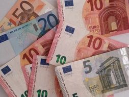 Euro banknotes of different denominations on the table