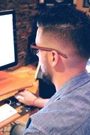 man sitting at the computer