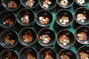 coins in ceramic cups