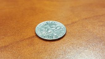 dime on a wooden table close-up