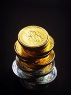 tower of coins on a black background