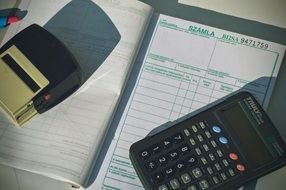 stamp, invoice and calculator