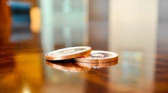 coins on a mirrored table
