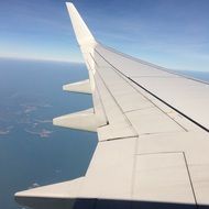 white Plane Wing in sky above water