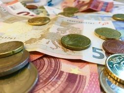 coins on bills of different denominations