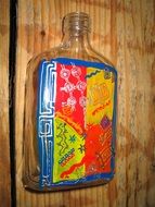 colored bottle on the background of wooden board