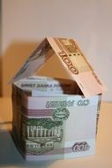 money stacked in the shape of a house