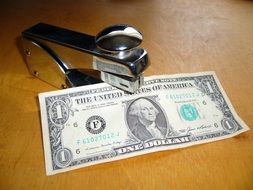 dollar near the stapler
