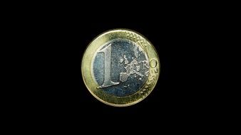 1 euro coin on the black background