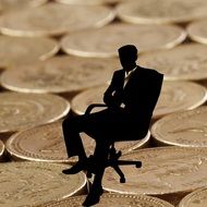 businessman in chair on the coins background