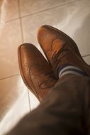 man in brown leather shoes