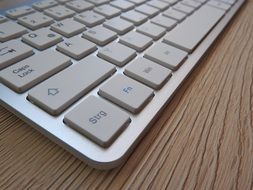 white keyboard on a wooden table