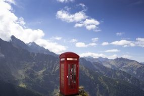 red telephone box on a mountain background