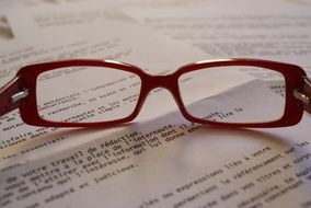 glasses on a textbook close-up on blurred background