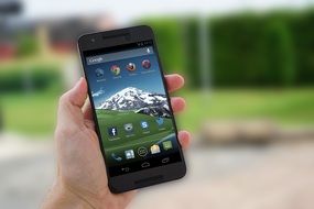 smartphone with the image of the mountains on the screen saver