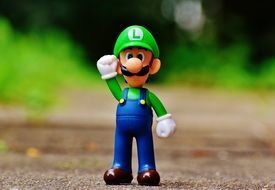 super mario with hand raised in the park