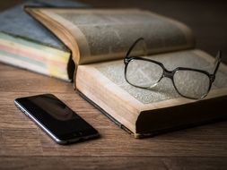 Phone and book and glasses