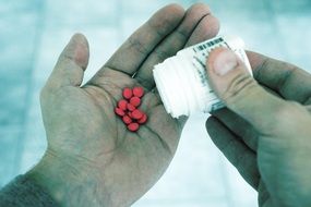 pills in man's hand