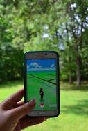 Pokemongo, Cell Phone in woman’s hand outdoor