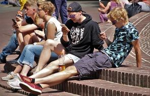 young people playing in smartphones