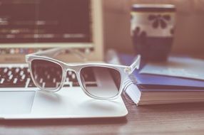 Sunglasses, Cup and Laptop