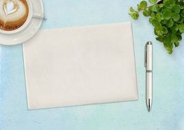 desktop paper sheet, pen, coffee Cup and flower